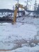 excavator in the frozen lake